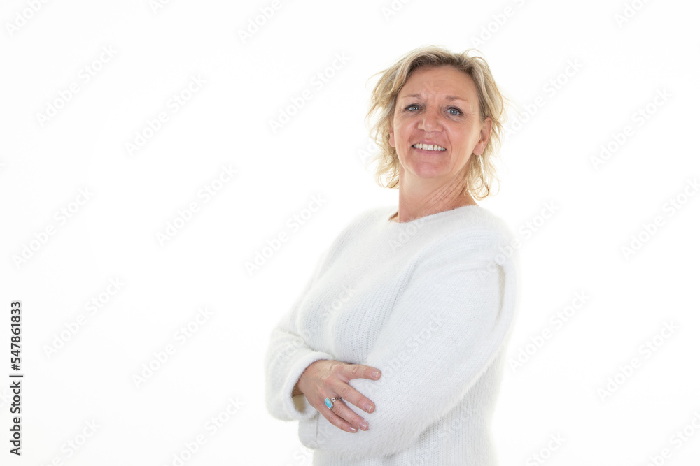 smiling older woman blond with arms crossed lady in wool sweater white background smiling older woman blond with arms crossed lady in wool sweater white background