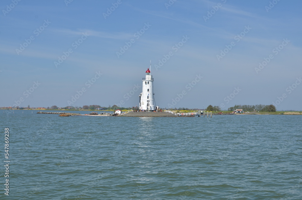 lighthouse in netherlands at seablue sky water