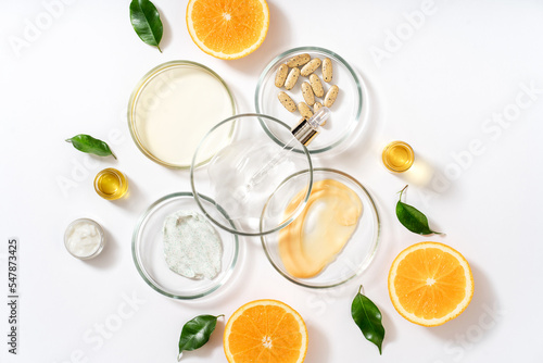 Alternative natural medicine and glass labware  petri dish  cream jars  scrub  aroma oils. Avocado oil and fruit. Natural cosmetics healthy lifestyle.