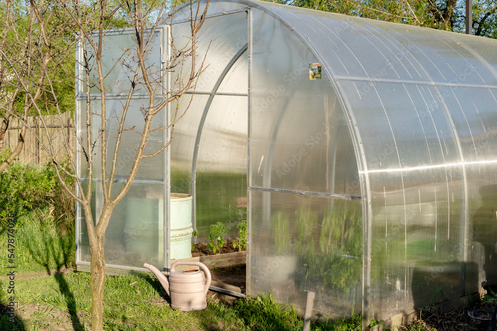 greenhouse on a private plot on a sunny day greenhouse on a private plot on a sunny day