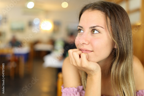 Happy teen looking at side in a restaurant