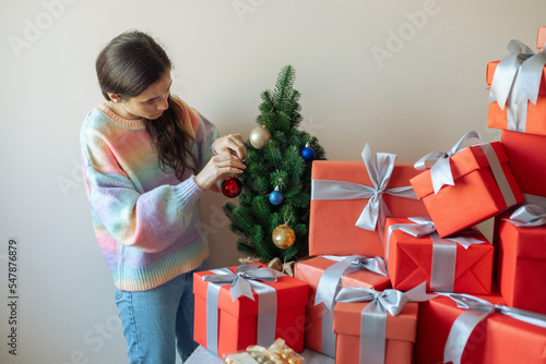 portrait of a girl in the process of decorating a Christmas tree photo