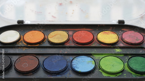 Colors on watercolor palette closeup. 