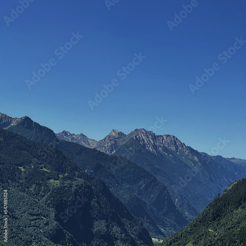 Picturesque view of mountain hill, forest, sky and clouds. Scenic nature landscape. Summer vacation travel