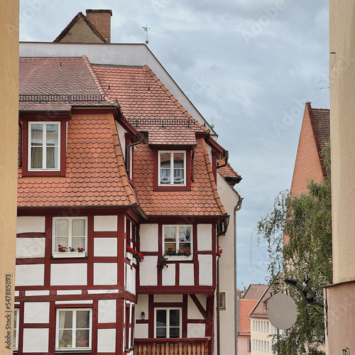 Old historic architecture in Nuremberg, Germany. Traditional European old town buildings with wooden windows, shutters and colourful pastel walls. Aesthetic summer vacation, tourism background