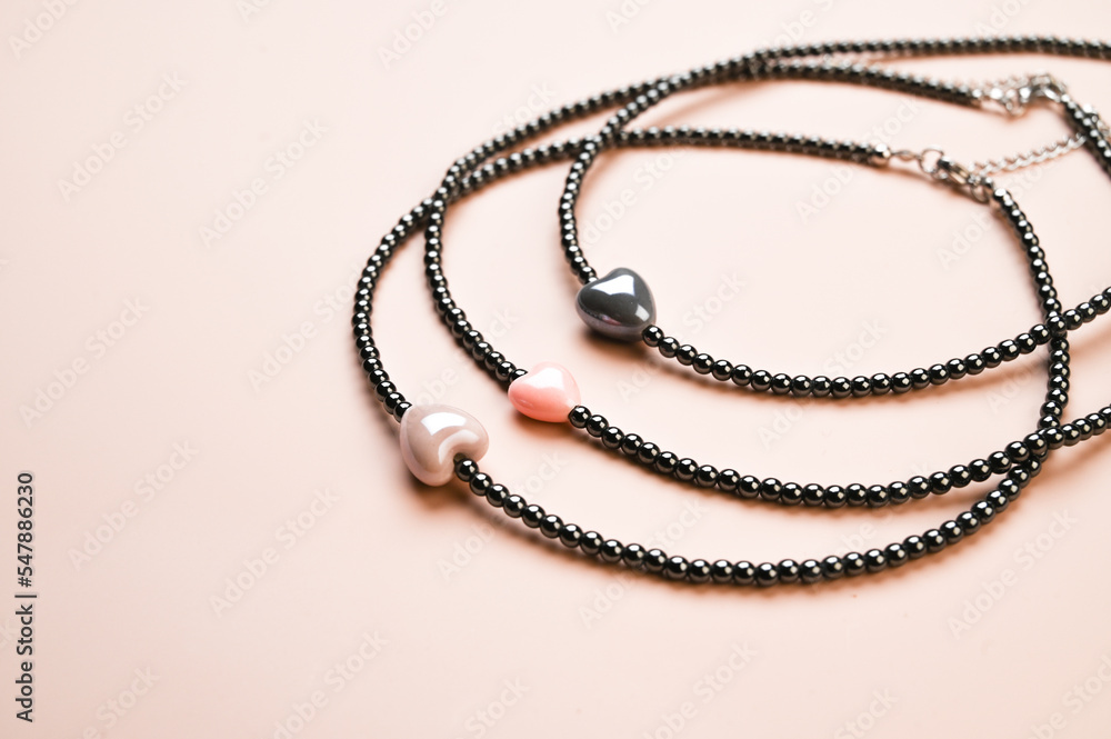 Set of round necklaces from beads on pastel pink background Set of round necklaces from beads on pastel pink background