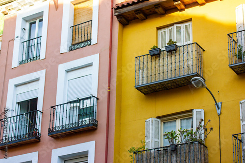 Yellow pink facades of apartment buildings houses in classical style. Balconies.