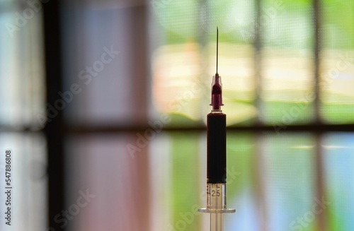 Close up of injection blood test syringe on the blurry background