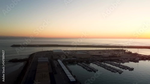 Establishing shot of boats anchored in a port during sunset photo