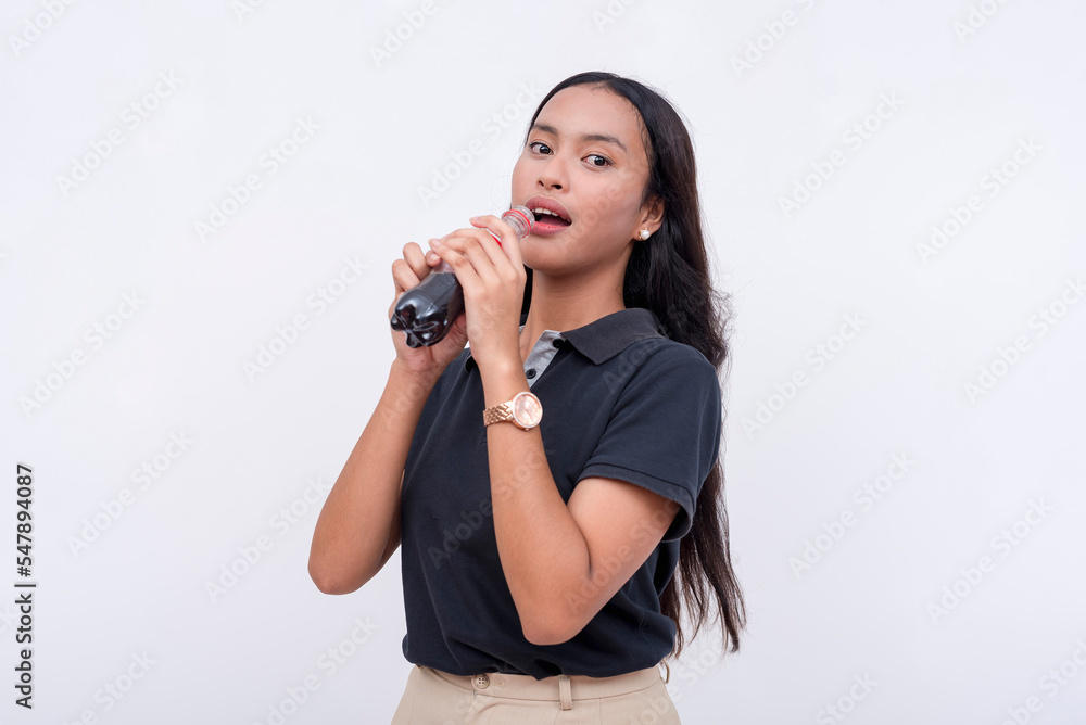 A young thirsty office employee drinking a refreshing bottle of cola. Isolated in white backdrop. A young thirsty office employee drinking a refreshing bottle of cola. Isolated in white backdrop.