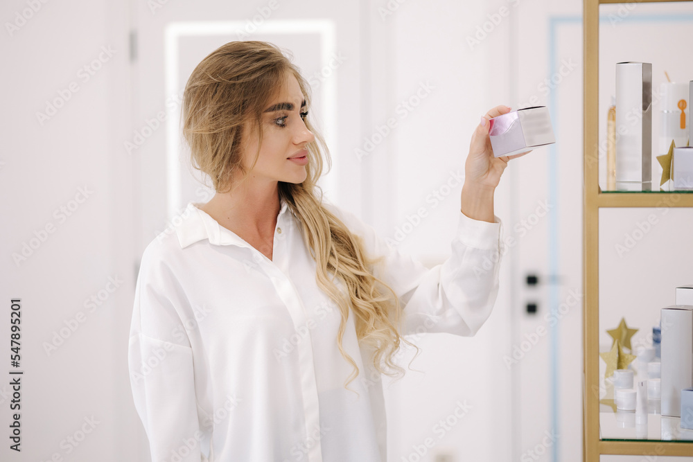 Elegant woman hold some cosmetic and look. Beauty studio. Luxuty female Elegant woman hold some cosmetic and look. Beauty studio. Luxuty female