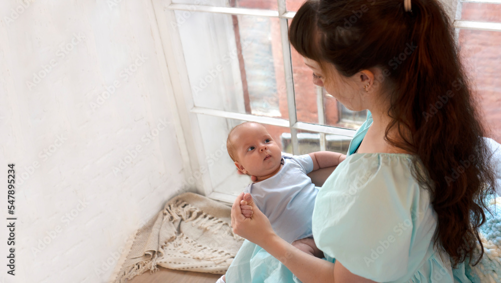 Young beautiful mother with her healthy newborn baby boy. Happy motherhood. Copy space. Young beautiful mother with her healthy newborn baby boy. Happy motherhood. Copy space.