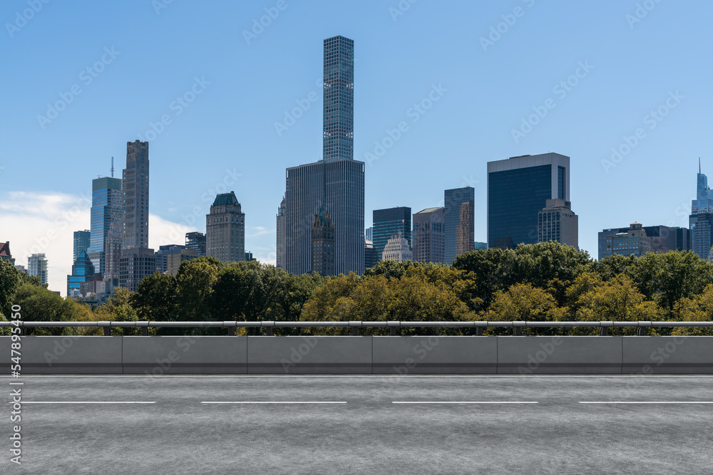 Fototapeta premium Empty urban asphalt road exterior with city buildings background. New modern highway concrete construction. Concept of way to success. Transportation logistic industry fast delivery. New York. USA.
