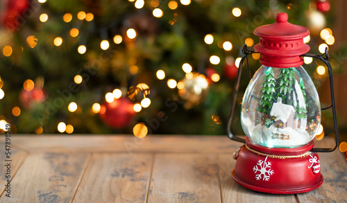 New Year's magic ball in the form of a lantern on the background of a Christmas tree. Mockup, copy space