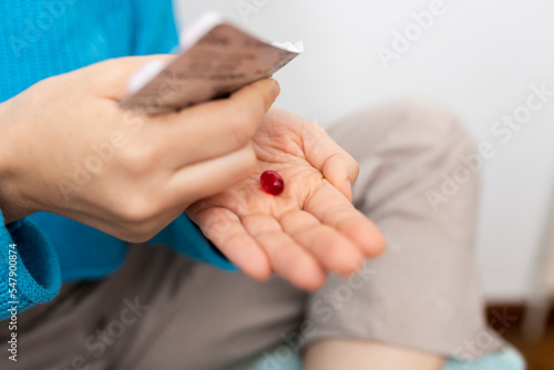 selective view of woman's hand holding blister pack of pain killer pill or vitamins. self-medication prescription drugs