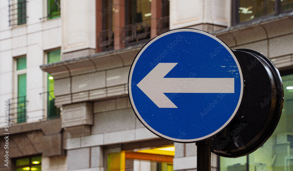 One way street sign in a  city street