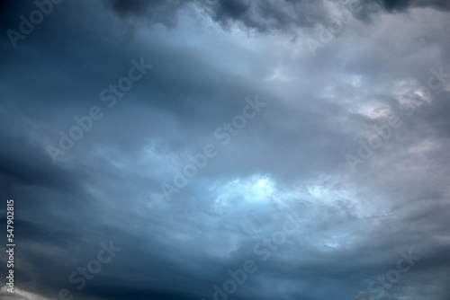Picturesque view of bird in sky with heavy rainy clouds