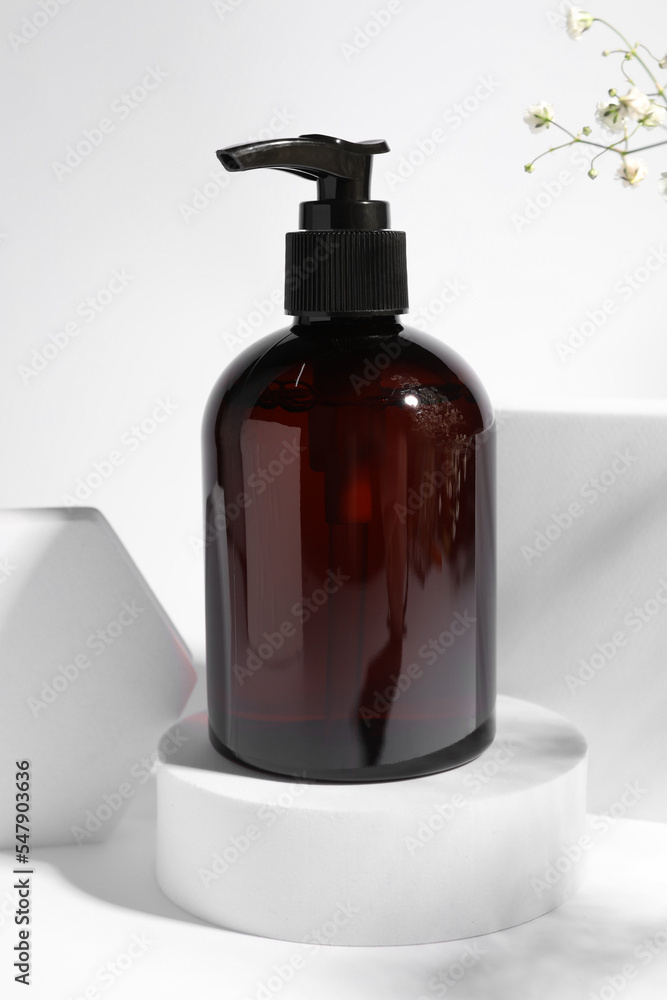 Bottle of shampoo on podium against white background Bottle of shampoo on podium against white background