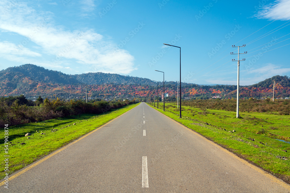 Empty asphalt road to the mountains