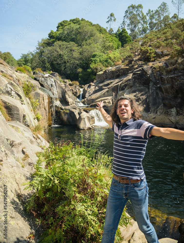 Naklejka premium Young man shows us a natural landscape