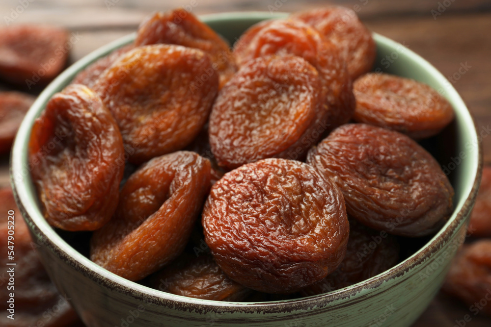 Bowl of tasty apricots on table, closeup. Dried fruits Bowl of tasty apricots on table, closeup. Dried fruits