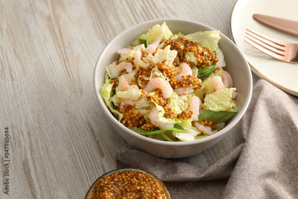 Delicious salad with Chinese cabbage, shrimps and mustard seed dressing on white wooden table, space for text Delicious salad with Chinese cabbage, shrimps and mustard seed dressing on white wooden table, space for text