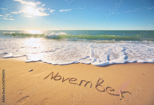 November word on sea sand.