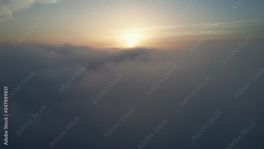 View from the cockpit of an airplane above the clouds at sunrise. View from the cockpit of an airplane above the clouds at sunrise.