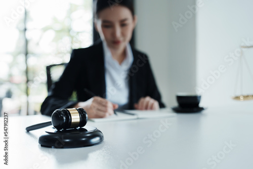 Portrait of a beautiful Asian lawyer studying a lawsuit for a client before going to court