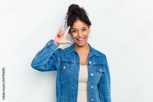 Fototapeta Young african american woman isolated showing a horns gesture as a revolution concept