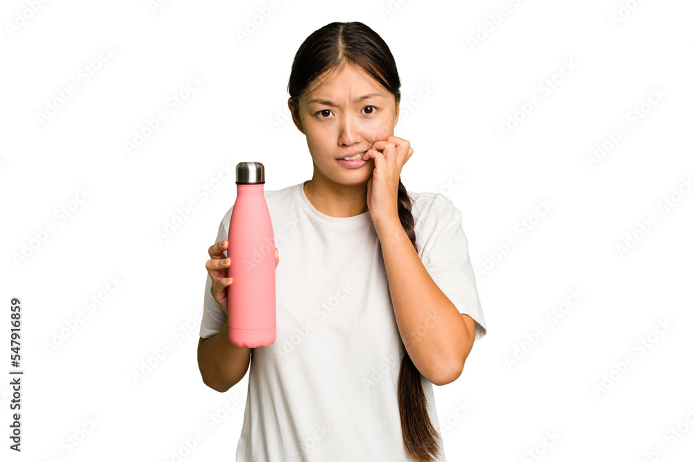 Young asian woman holding a pink thermo isolated biting fingernails, nervous and very anxious. Young asian woman holding a pink thermo isolated biting fingernails, nervous and very anxious.