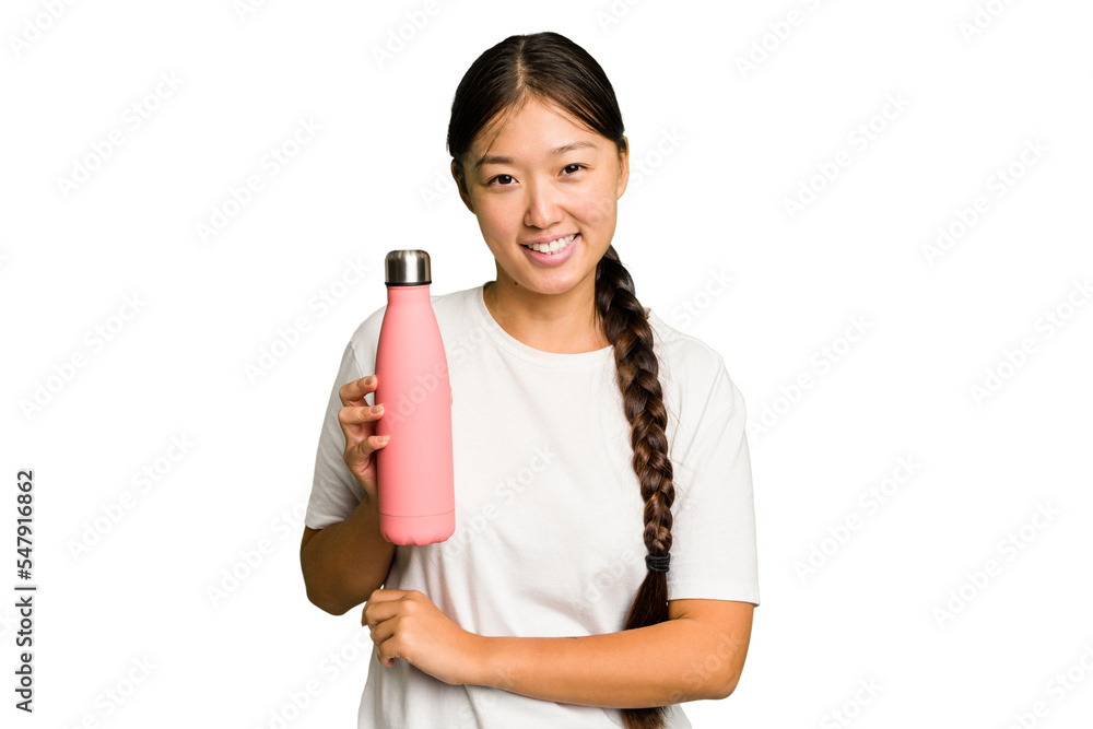Young asian woman holding a pink thermo isolated laughing and having fun. Young asian woman holding a pink thermo isolated laughing and having fun.