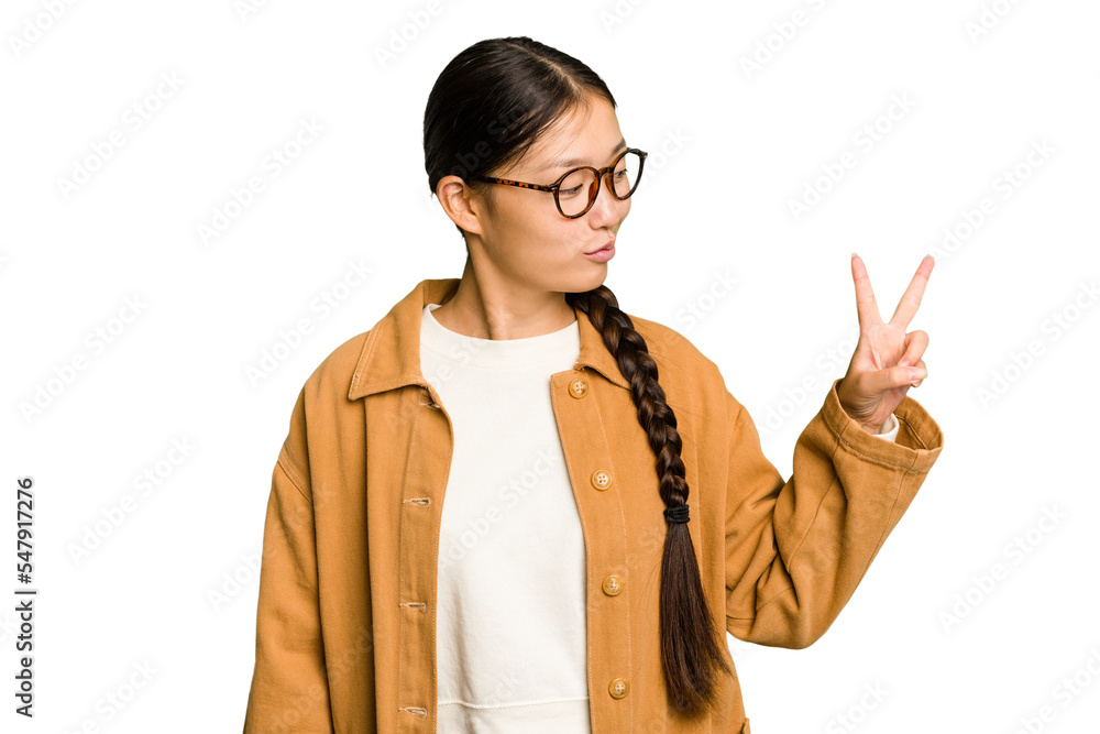 Young Asian woman isolated joyful and carefree showing a peace symbol with fingers. Young Asian woman isolated joyful and carefree showing a peace symbol with fingers.