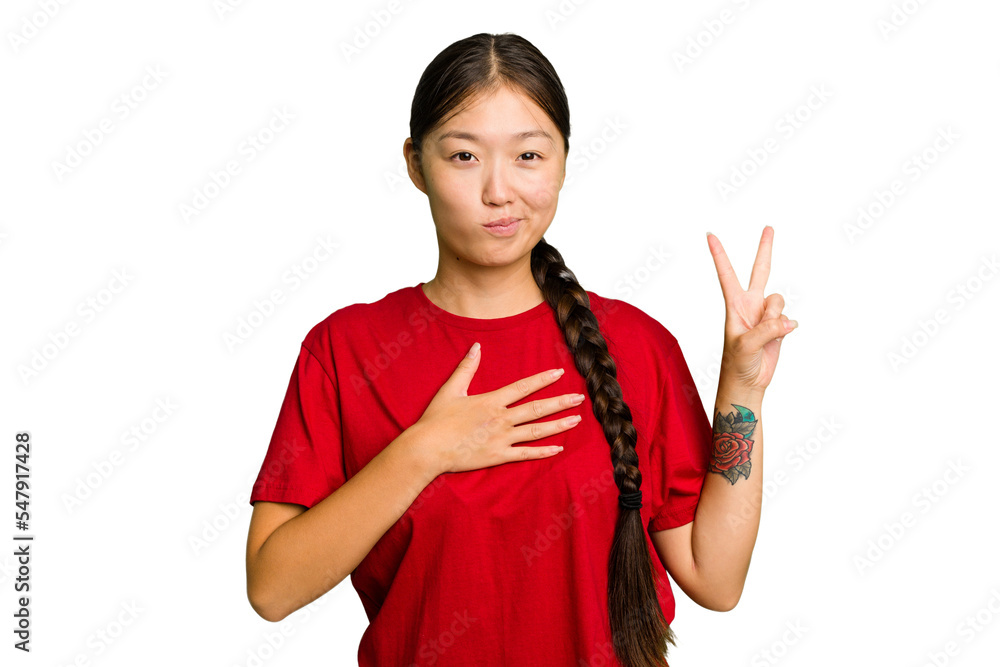 Young Asian woman isolated taking an oath, putting hand on chest.