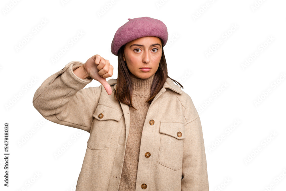 Fototapeta premium Young caucasian woman wearing winter jacket isolated showing a dislike gesture, thumbs down. Disagreement concept.