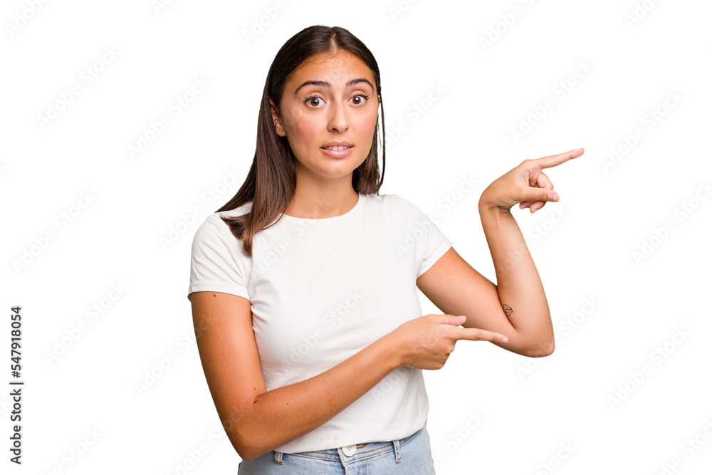 Young cute caucasian woman isolated shocked pointing with index fingers to a copy space. Young cute caucasian woman isolated shocked pointing with index fingers to a copy space.