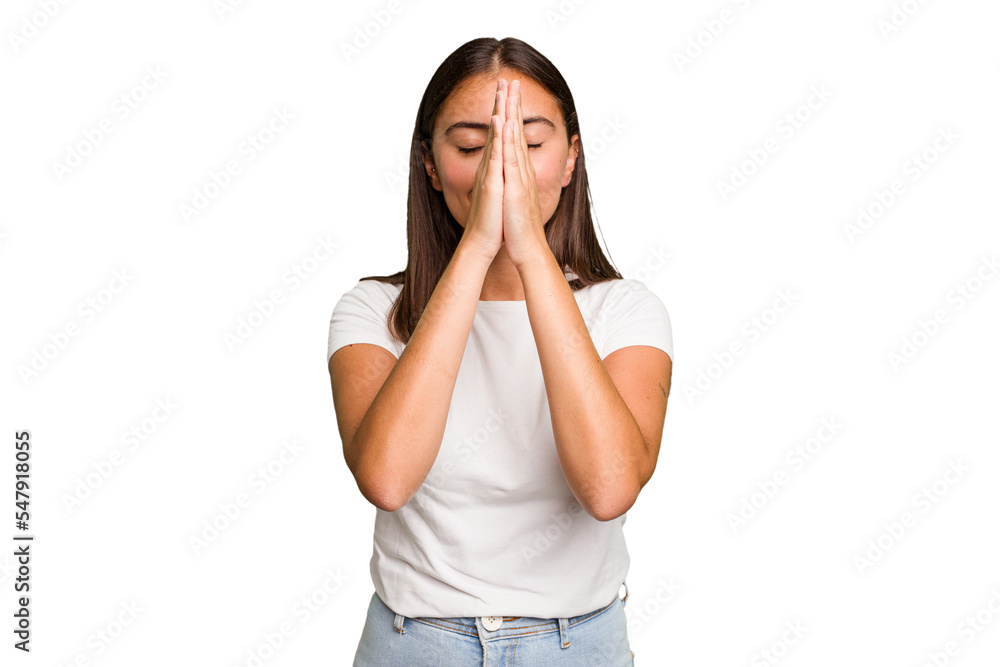 Young cute caucasian woman isolated holding hands in pray near mouth, feels confident. Young cute caucasian woman isolated holding hands in pray near mouth, feels confident.