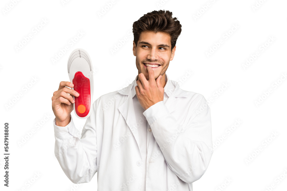 Young caucasian chiropodist man isolated relaxed thinking about something looking at a copy space. Young caucasian chiropodist man isolated relaxed thinking about something looking at a copy space.