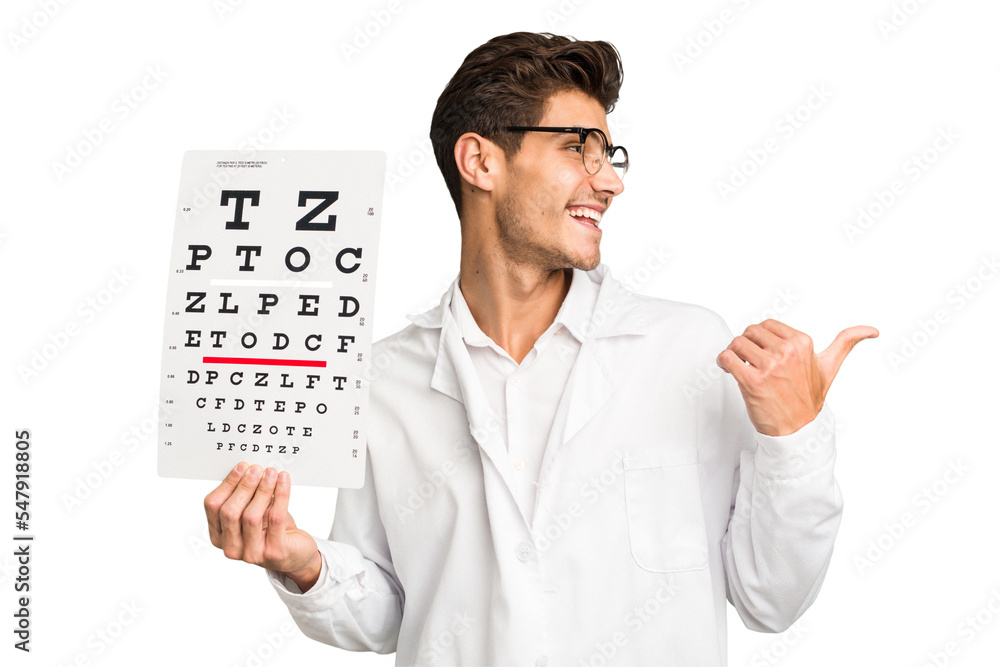 Young caucasian oculist man isolated points with thumb finger away, laughing and carefree. Young caucasian oculist man isolated points with thumb finger away, laughing and carefree.