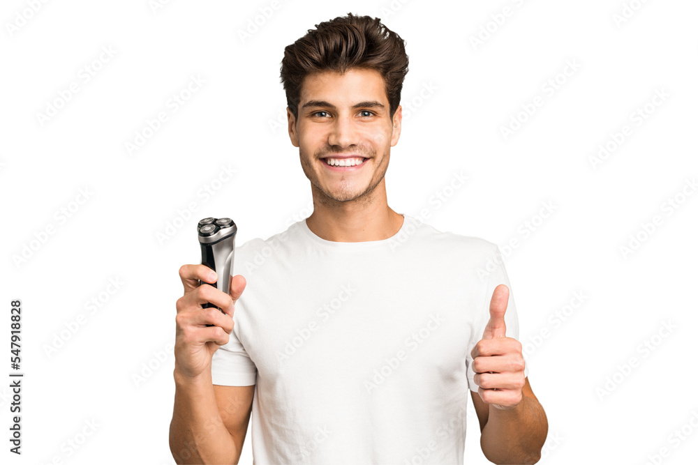 Young caucasian man holding a razor isolated smiling and raising thumb up Young caucasian man holding a razor isolated smiling and raising thumb up