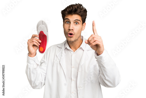 Young caucasian chiropodist man isolated having an idea, inspiration concept.