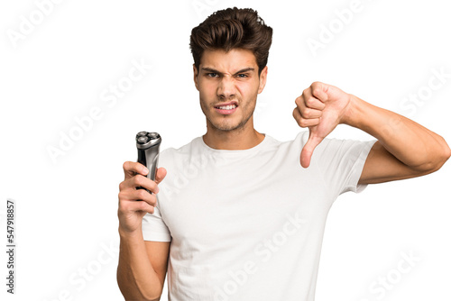 Young caucasian man holding a razor isolated showing a dislike gesture, thumbs down. Disagreement concept.