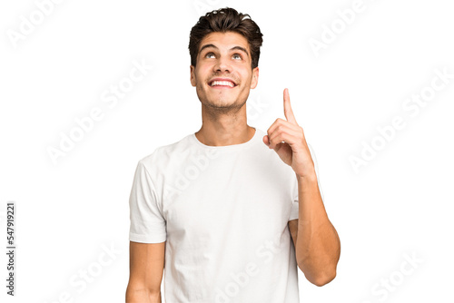 Foto Young caucasian handsome man isolated indicates with both fore fingers up showing a blank space