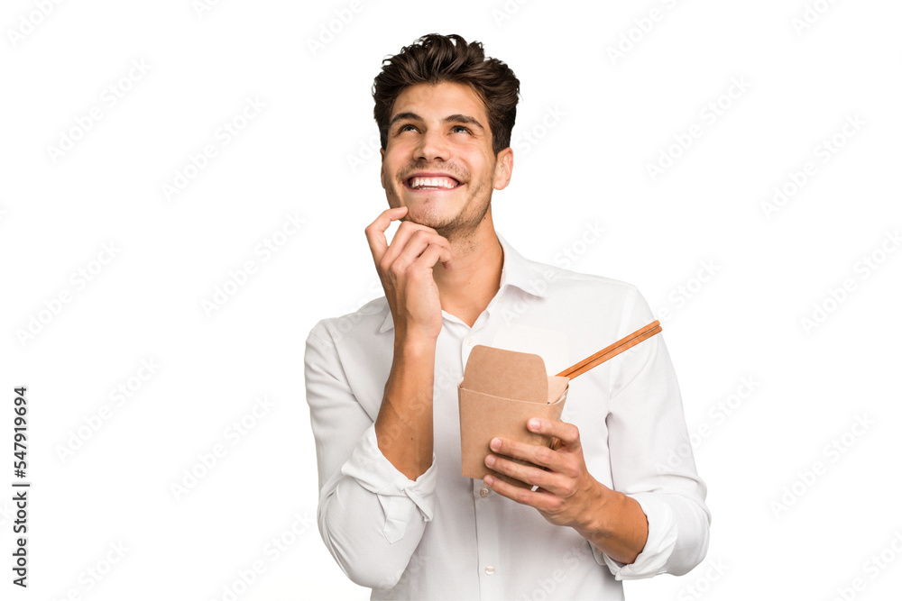 Young caucasian man eating a takeaway noodles isolated Young caucasian man eating a takeaway noodles isolated