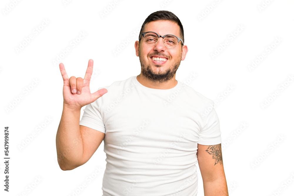 Young caucasian man isolated showing a horns gesture as a revolution concept. Young caucasian man isolated showing a horns gesture as a revolution concept.