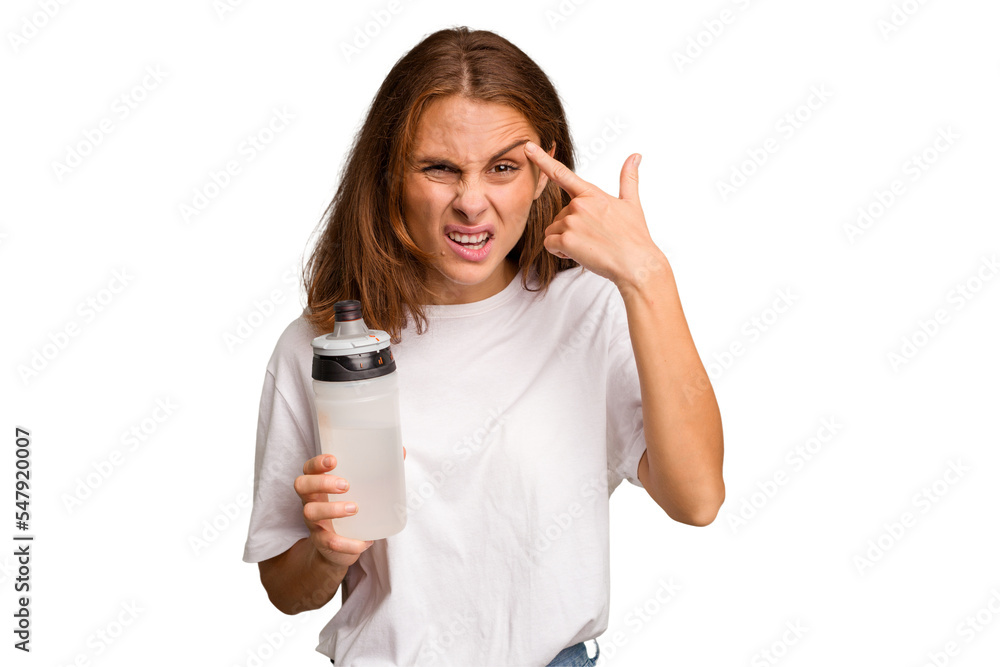 Young caucasian sport woman holding a bottle of water isolated showing a disappointment gesture with forefinger. Young caucasian sport woman holding a bottle of water isolated showing a disappointment gesture with forefinger.