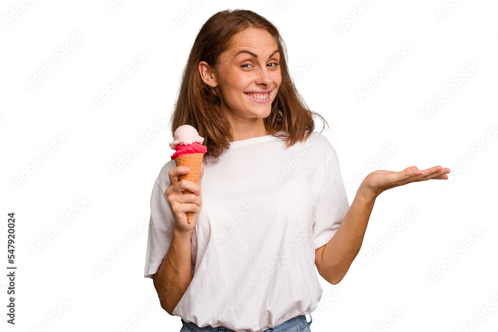 Young caucasian woman holding an ice cream isolated showing a copy space on a palm and holding another hand on waist. Young caucasian woman holding an ice cream isolated showing a copy space on a palm and holding another hand on waist.