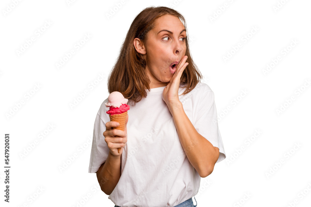 Young caucasian woman holding an ice cream isolated is saying a secret hot braking news and looking aside Young caucasian woman holding an ice cream isolated is saying a secret hot braking news and looking aside