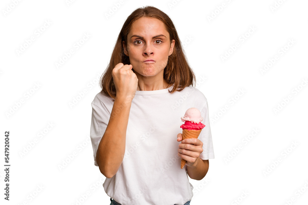 Young caucasian woman holding an ice cream isolated showing fist to camera, aggressive facial expression. Young caucasian woman holding an ice cream isolated showing fist to camera, aggressive facial expression.