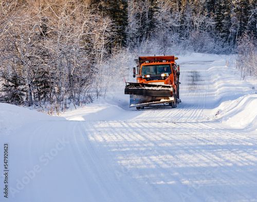 Snow plough cleared wintery rural forest road